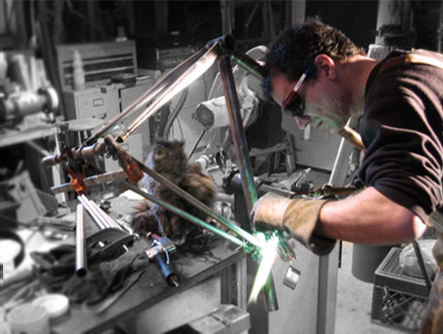 Owner/Builder Paul Evans welding a frame.